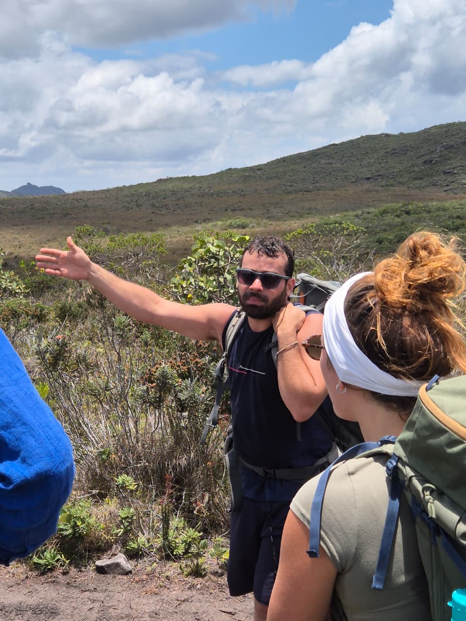 Trekkers crossing crystal-clear river during multi-day Pati trek
